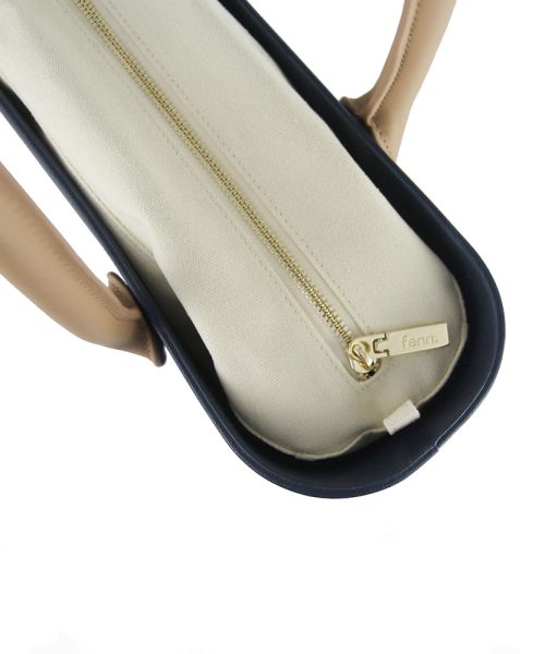 This Black Tote Bag features a stunning vinyl exterior that exudes sophistication while the handles and inners are interchangeable